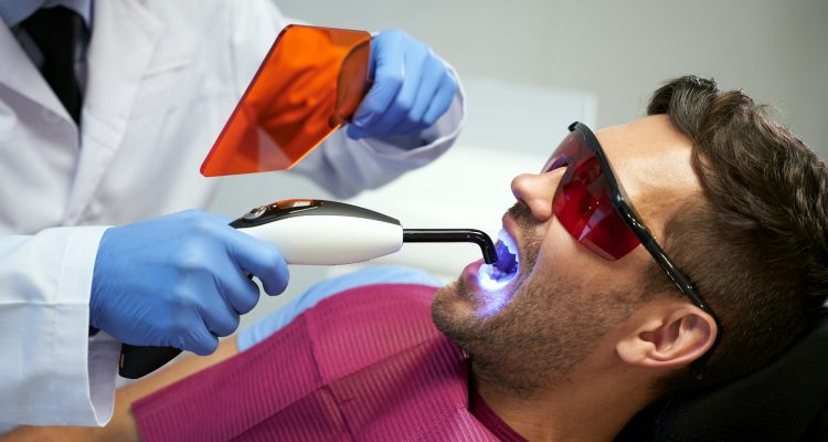 Dental clinic patient having his teeth treated with laser