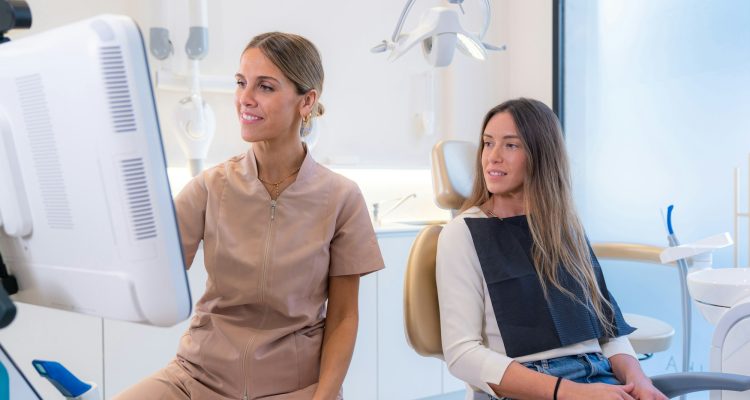 Patient and dentist looking at results in a screen