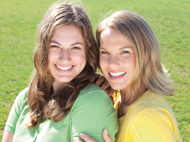 Two smiling women.